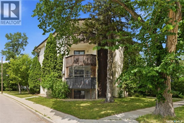 Close-up of apartment balconies with wooden railings and a screened lower level. - 301 116 111th Street, Saskatoon