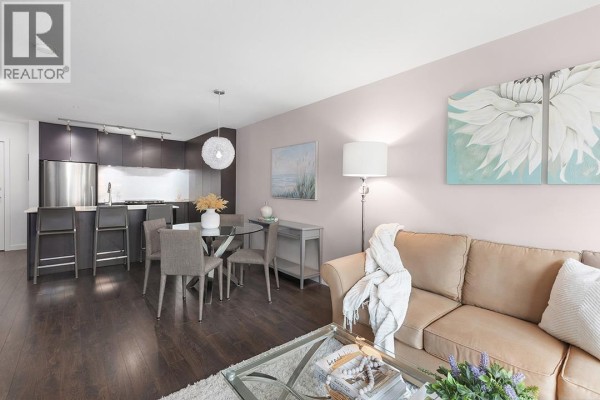 Open-concept living space featuring kitchen, dining area, and soft color palette. - 301 1673 Lloyd Avenue, North Vancouver
