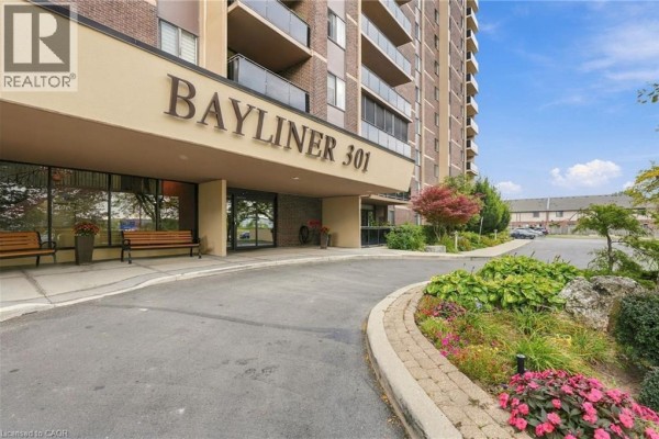 Entrance to Bayliner 301 building with paved driveway and landscaping. - 301 Frances Avenue Unit# 705, Hamilton