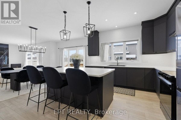 Modern kitchen with island and dark cabinetry - 301 Moonlight Drive Russell