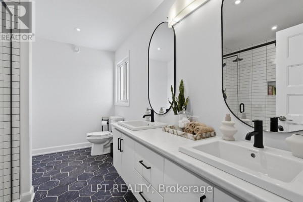 Modern bathroom with double vanity, hexagon tile, and walk-in shower - 301 Moonlight Drive Russell