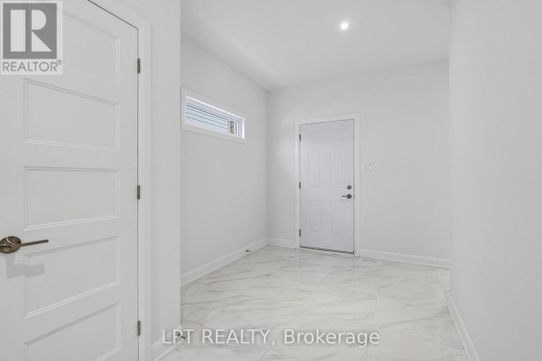 Hallway with white doors and marble tile flooring - 301 Moonlight Drive Russell