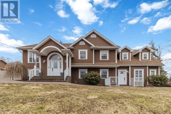 Brown two-story house with a large arched entryway and white railings under a daytime sky. - 301 Preakness Crescent, Fall River