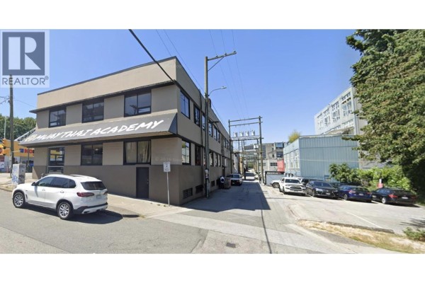 Side view of commercial building with alleyway and parked cars. - 301 W Broadway, Vancouver