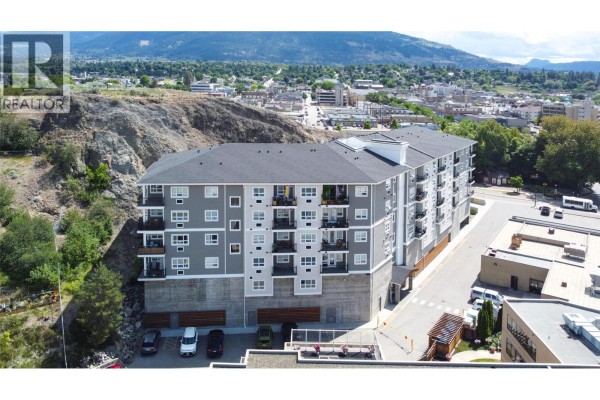 Aerial view of the apartment building showing the roof, balconies, and surrounding cityscape. - 3010 35 Street Unit# 207, Vernon