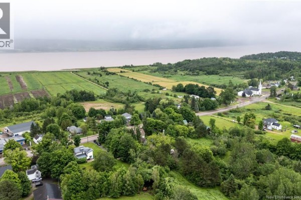 Aerial view of 3010 Main Street, Hillsborough, with a grey house and garden beds. - 3010 Main Street, Hillsborough
