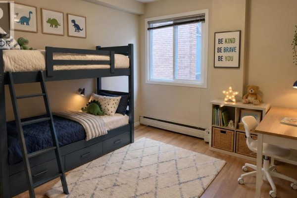 Interior view of a bedroom with mirrored closet doors and access to a hallway. - 302, 117 23 Avenue Sw, Calgary