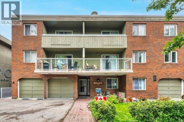 Close-up front exterior of the apartment building with a prominent sign reading 'NORAN HOUSE 1974'. - 302, 1814 18 Street Sw, Calgary
