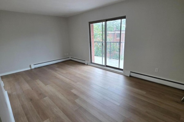 Small bedroom with a window, neutral walls, and hardwood flooring - 401 - 103 Emerald Street S, Hamilton
