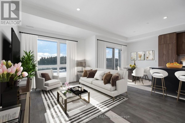 Living room with sofa, armchair, large window with winter view, and balcony door. - 302 - 11 Walder Lane, Richmond Hill