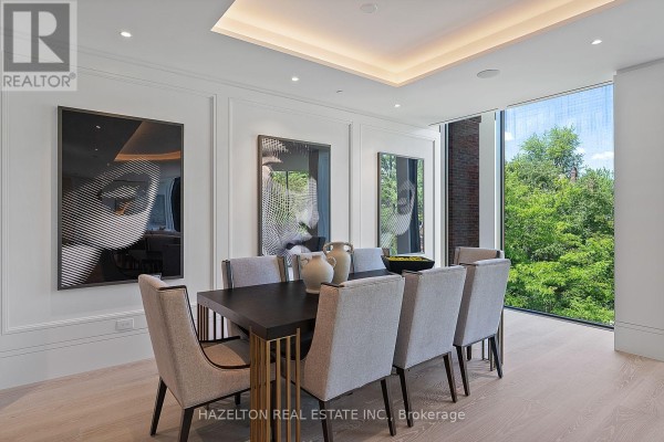 Modern covered walkway with stone accents, water feature, and abstract sculpture. - 302 - 7 Dale Avenue, Toronto