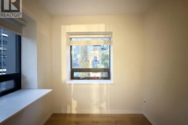 Room with two windows showing city views and sunlight streaming in. - 302 1331 Alberni Street, Vancouver