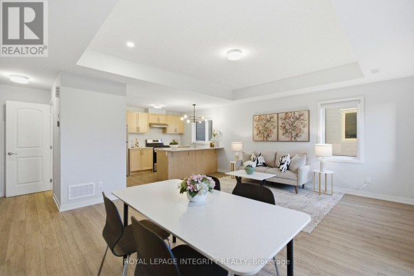 Open concept living, dining, and kitchen area with light wood cabinetry. - 302 Parnian Private, Ottawa