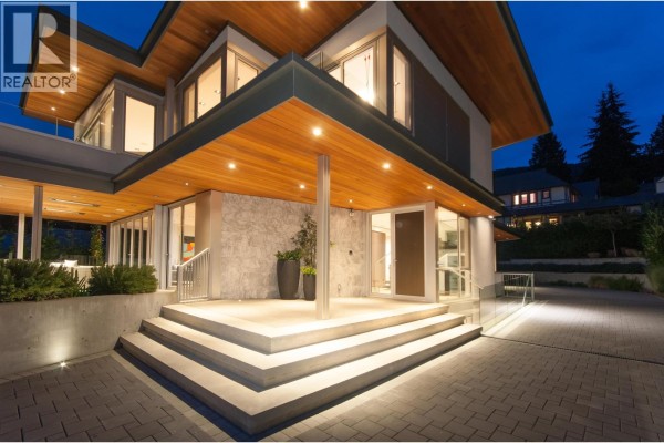 Stone textured facade with wide concrete stairs leading to the main entrance. - 3023 Mathers Avenue, West Vancouver