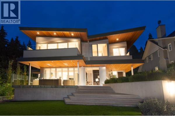 Rear exterior of the house with tiered concrete steps and a green lawn. - 3023 Mathers Avenue, West Vancouver