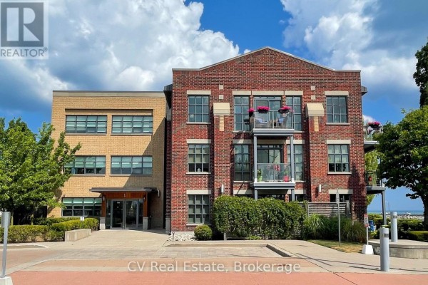 Front facade of a brick apartment building with multiple balconies and large windows. - 303 - 1 Shipyard Lane, Collingwood