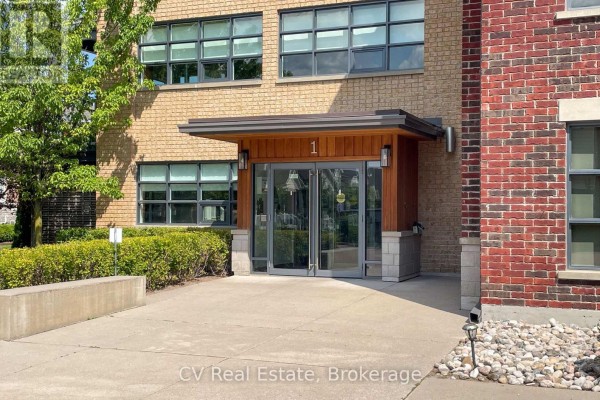 Close-up of the main entrance to apartment building with wooden soffits and glass doors. - 303 - 1 Shipyard Lane, Collingwood