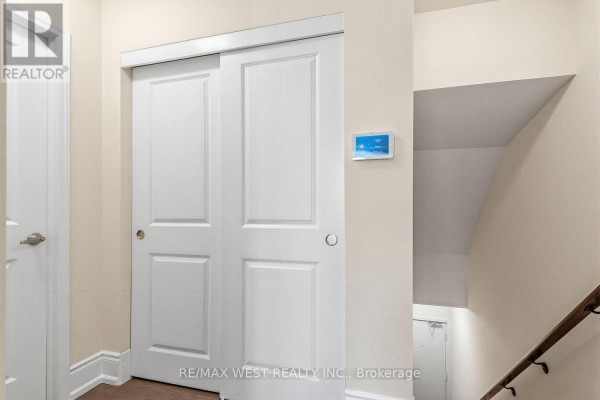 Interior hallway with white bi-fold closet doors and staircase. - 303 - 1150 Briar Hill Avenue, Toronto