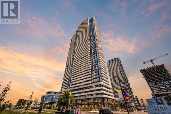 Tall condominium towers with balconies at sunset with construction cranes nearby. - 303 - 195 Commerce Street, Vaughan