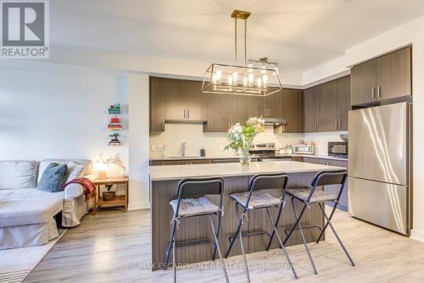 Modern kitchen with island and seating - 303 - 320 Plains Road E Burlington