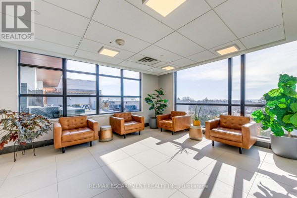Leather armchairs with large windows and city views - 303 - 320 Plains Road E Burlington