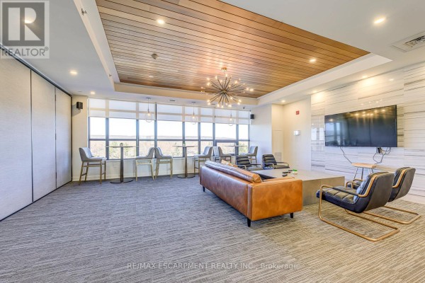 Living room with leather sofa, modern chairs, TV, and wood ceiling - 303 - 320 Plains Road E Burlington