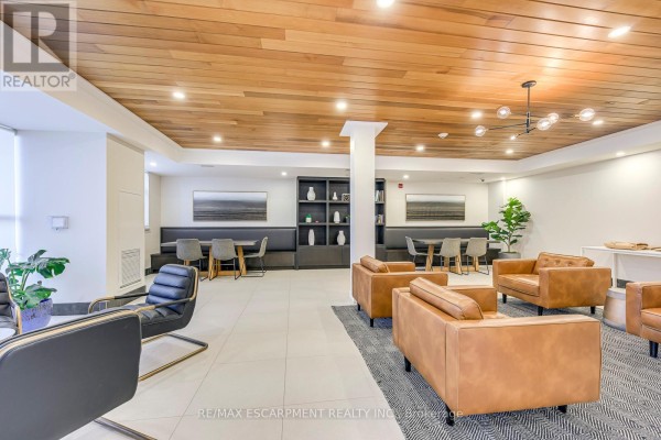 Communal lounge with leather sofas, booths, and wood ceiling - 303 - 320 Plains Road E Burlington