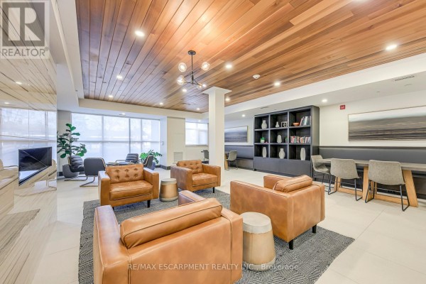 Tan leather armchairs and communal table with wood ceiling - 303 - 320 Plains Road E Burlington
