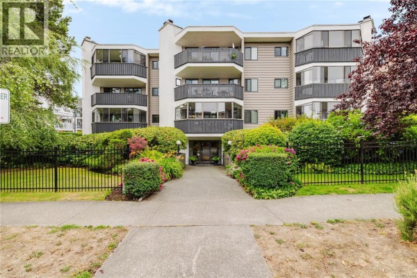 Apartment building exterior with balconies, windows, and landscaping. - 303 1031 Burdett Ave, Victoria