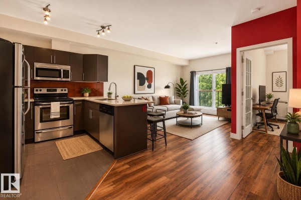 Open-concept kitchen and living room with dark cabinets and stainless steel appliances. - #303 10611 117 St Nw, Edmonton