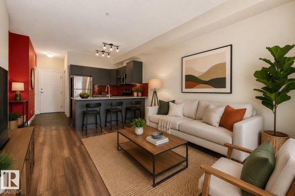 Living room with a sofa, coffee table, and view into the kitchen. - #303 10611 117 St Nw, Edmonton