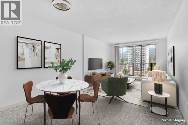 Apartment dining area with a round table and chairs, adjacent to kitchen. - 303 150 E 15th Street, North Vancouver