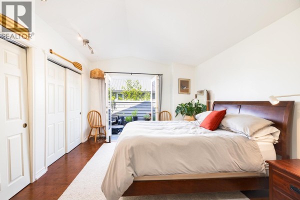 Spacious living room with a large sectional sofa, coffee table, and view of dining area. - 303 1528 Bowser Avenue, North Vancouver
