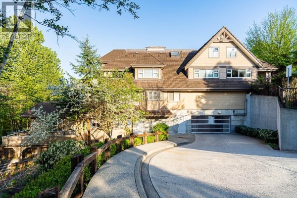 Exterior view of the Shoreline Villa apartment building with a driveway. - 303 160 Shoreline Circle, Port Moody