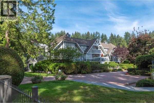 Aerial view of the apartment complex with arrows pointing to 'Your New Home' and 'Edgemont Village'. - 303 3373 Capilano Crescent, North Vancouver