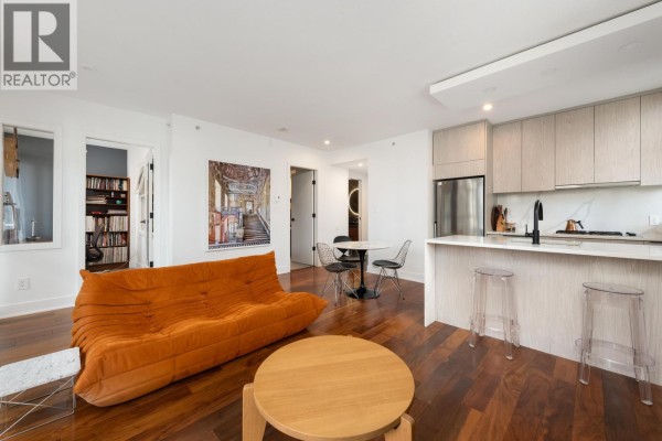 View of living space including kitchen, dining area, and living room seating. - 303 988 Richards Street, Vancouver