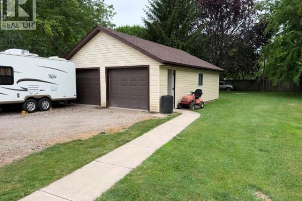 Two-car garage with RV parking and lawnmower - 303 Wellington Street West Chatham
