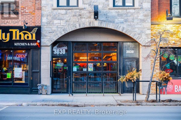 Entrance view of '3030' with large glass doors and decorative elements - 3030 Dundas Street W, Toronto