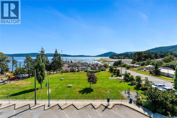 View from apartment balcony of a park, marina, and distant treed hills. - 304 1533 Joan Ave, Crofton