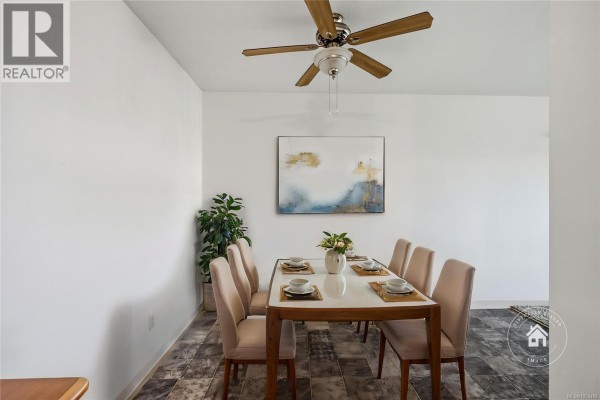 Dining room with rectangular table, six chairs, ceiling fan, and abstract artwork. - 304 266 Hirst Ave, Parksville