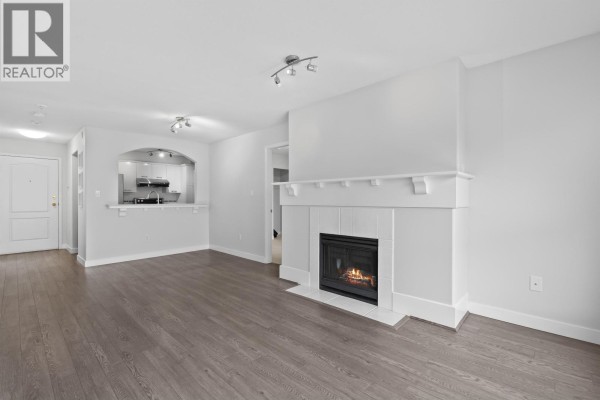 Walk-in closet with metal shelving and a dark wood floor. - 304 5500 Lynas Lane, Richmond