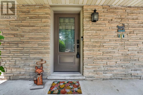 Front door with stained glass detail, stone facade, and welcome mat. - 304 Eliza Street, Wellington North