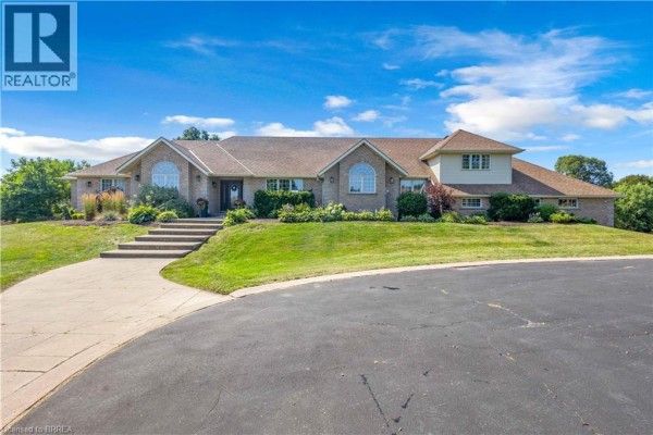 Front exterior of a large brick home at 304 German School Road with a circular driveway and landscaped lawn. - 304 German School Road, Paris