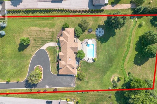 Aerial view of the backyard at 304 German School Road showing a swimming pool and expansive green lawn. - 304 German School Road, Paris