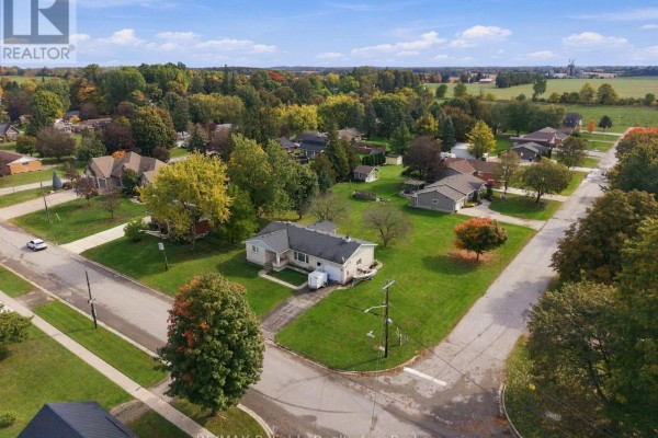 Aerial view of a residential street with a bungalow and surrounding homes. - 304 Morris Street, North Huron