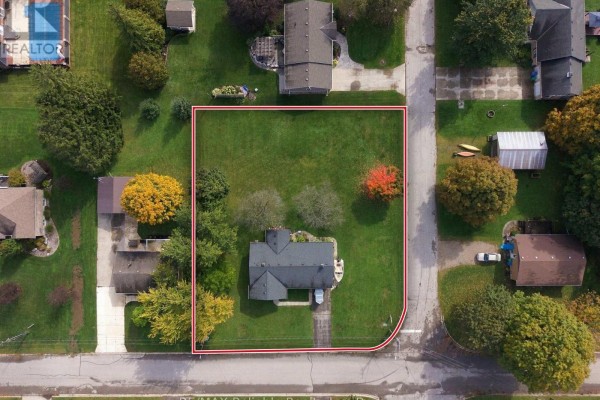Overhead view of a property lot with a house, driveway, and red boundary line. - 304 Morris Street, North Huron