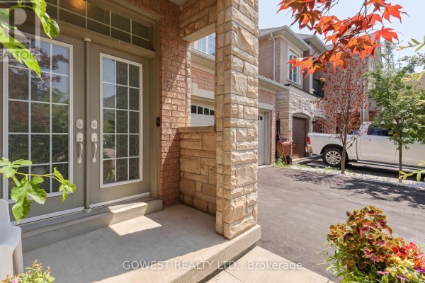 Double front doors with glass panels and stone pillar details. - 3045 Ferguson Drive, Burlington