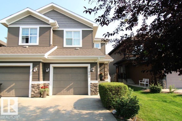 Close-up of the duplex exterior at 3048 Harvey Cr Nw, showing the garage and entrance. - 3048 Harvey Cr Nw, Edmonton