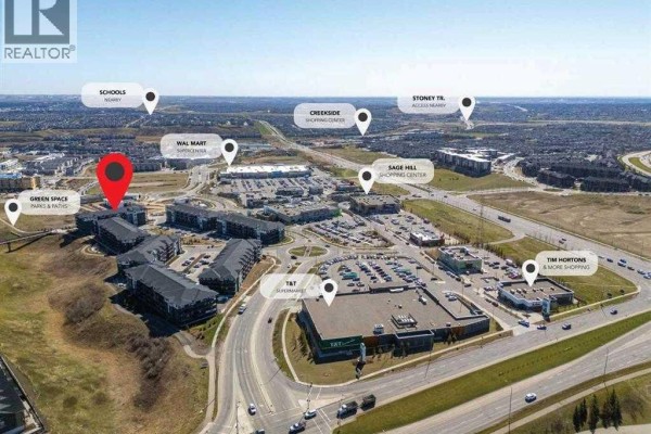 Aerial view showing the apartment buildings with surrounding amenities like shopping centers and schools labeled. - 305, 30 Sage Hill  Nw, Calgary