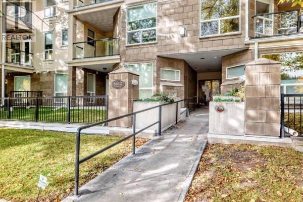 Close-up of the building entrance with a ramp and pillars numbered 3412. - 305, 3412 Parkdale Boulevard Nw, Calgary